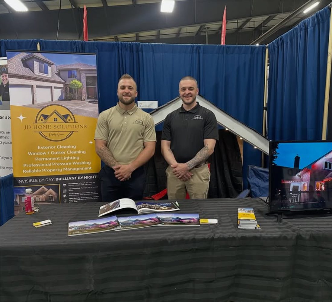 Jake and the JD Home Solutions team at a home show booth showcasing permanent lighting