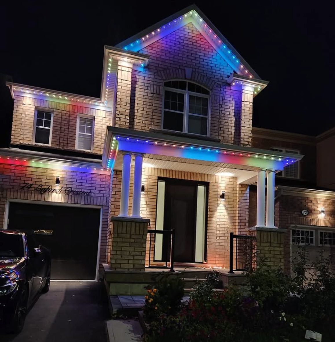 Two-storey home displaying full rainbow colours with app-controlled permanent lighting